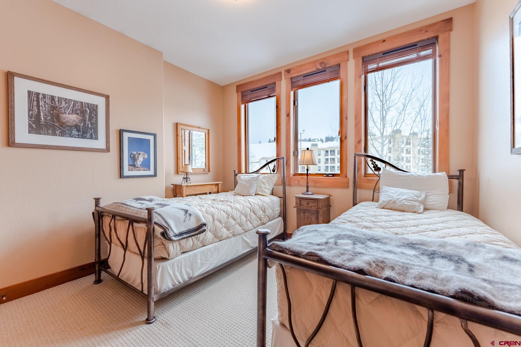 16 Snowmass Road, Unit 4 Crested Butte, CO 81225 - Photo 31 of 35 a bedroom with a bed and window