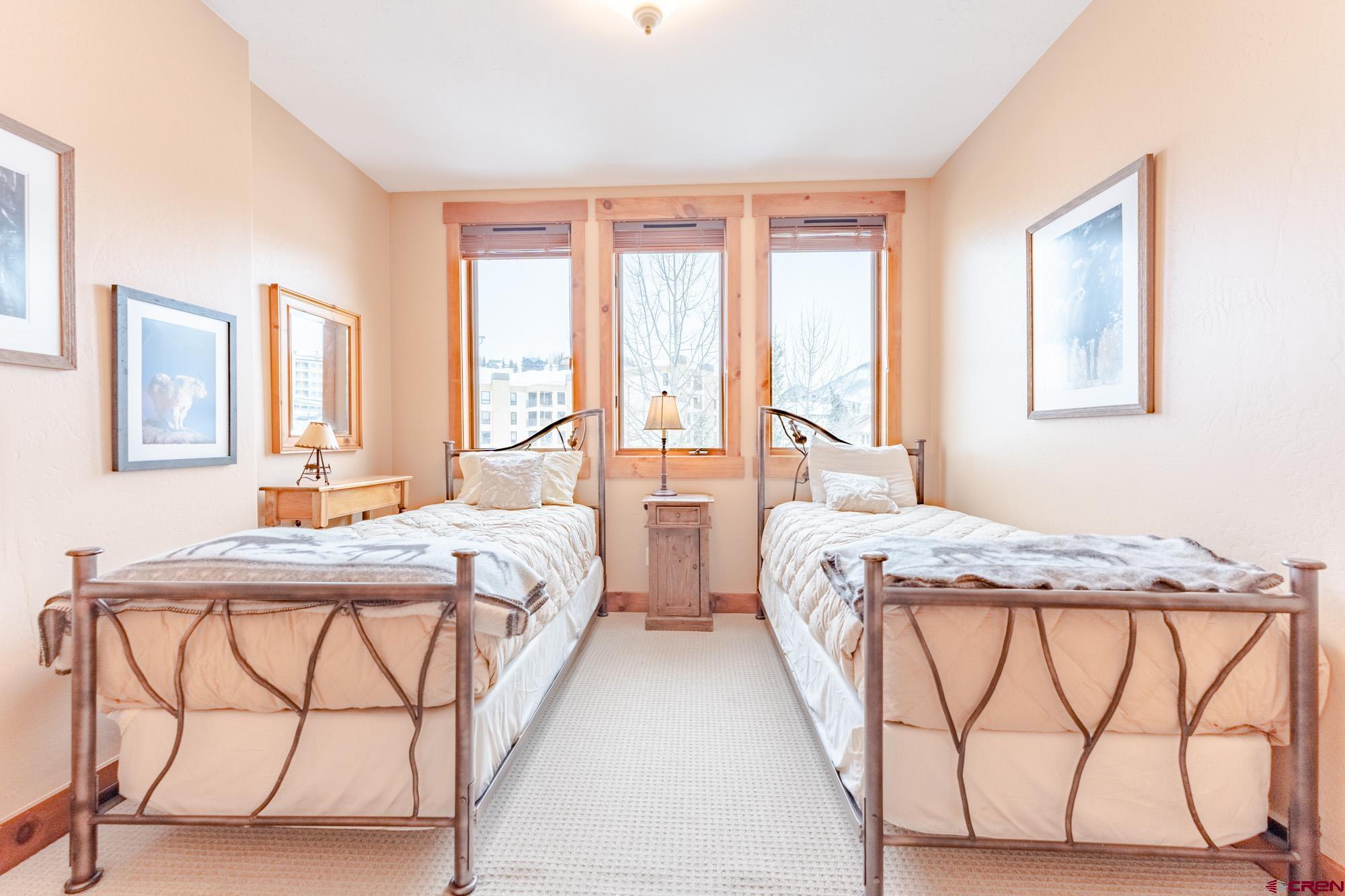 16 Snowmass Road, Unit 4 Crested Butte, CO 81225 - Photo 32 of 35 a bedroom with two beds and a table