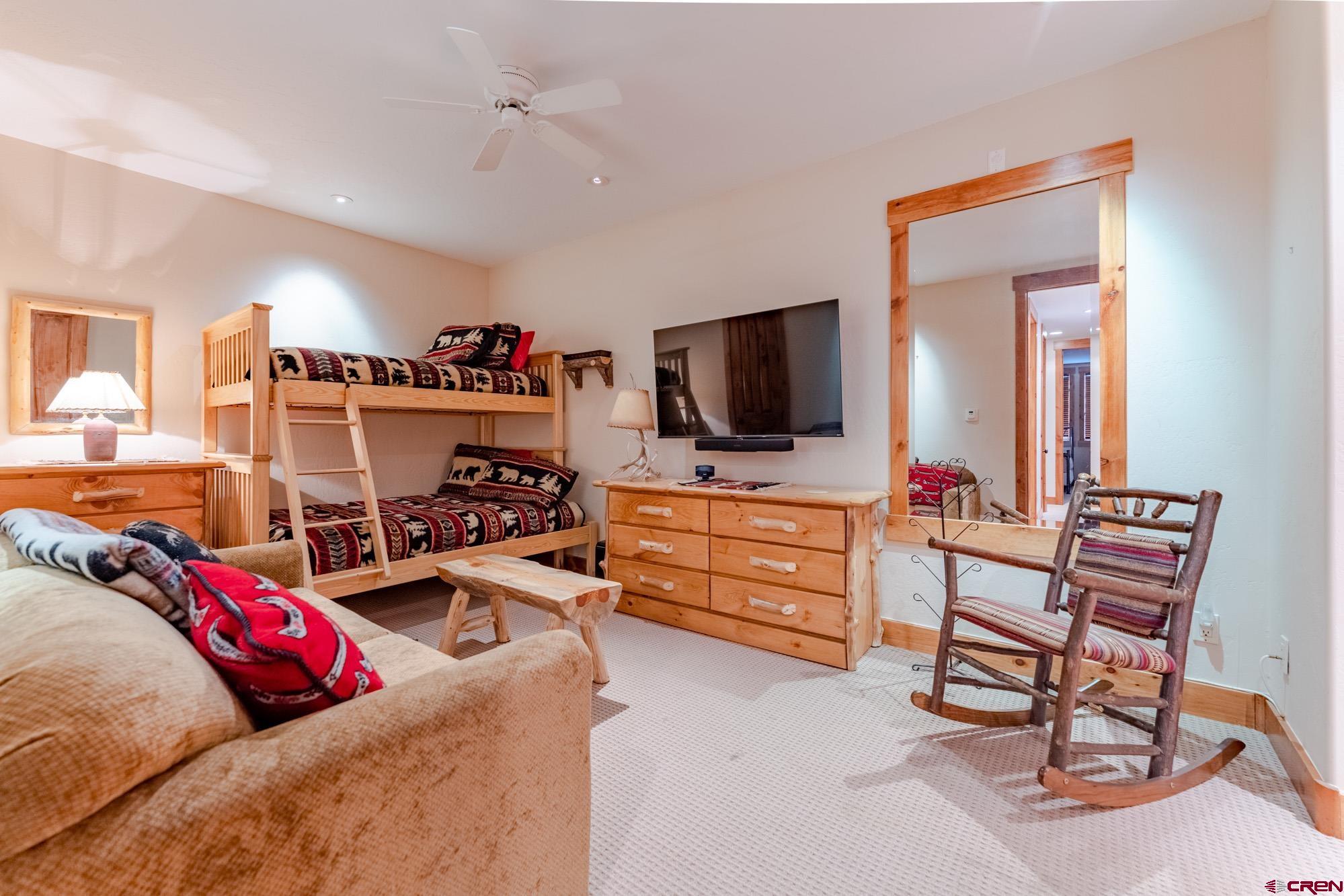 16 Snowmass Road, Unit 4 Crested Butte, CO 81225 - Photo 35 of 35 a bedroom with furniture and a flat screen tv
