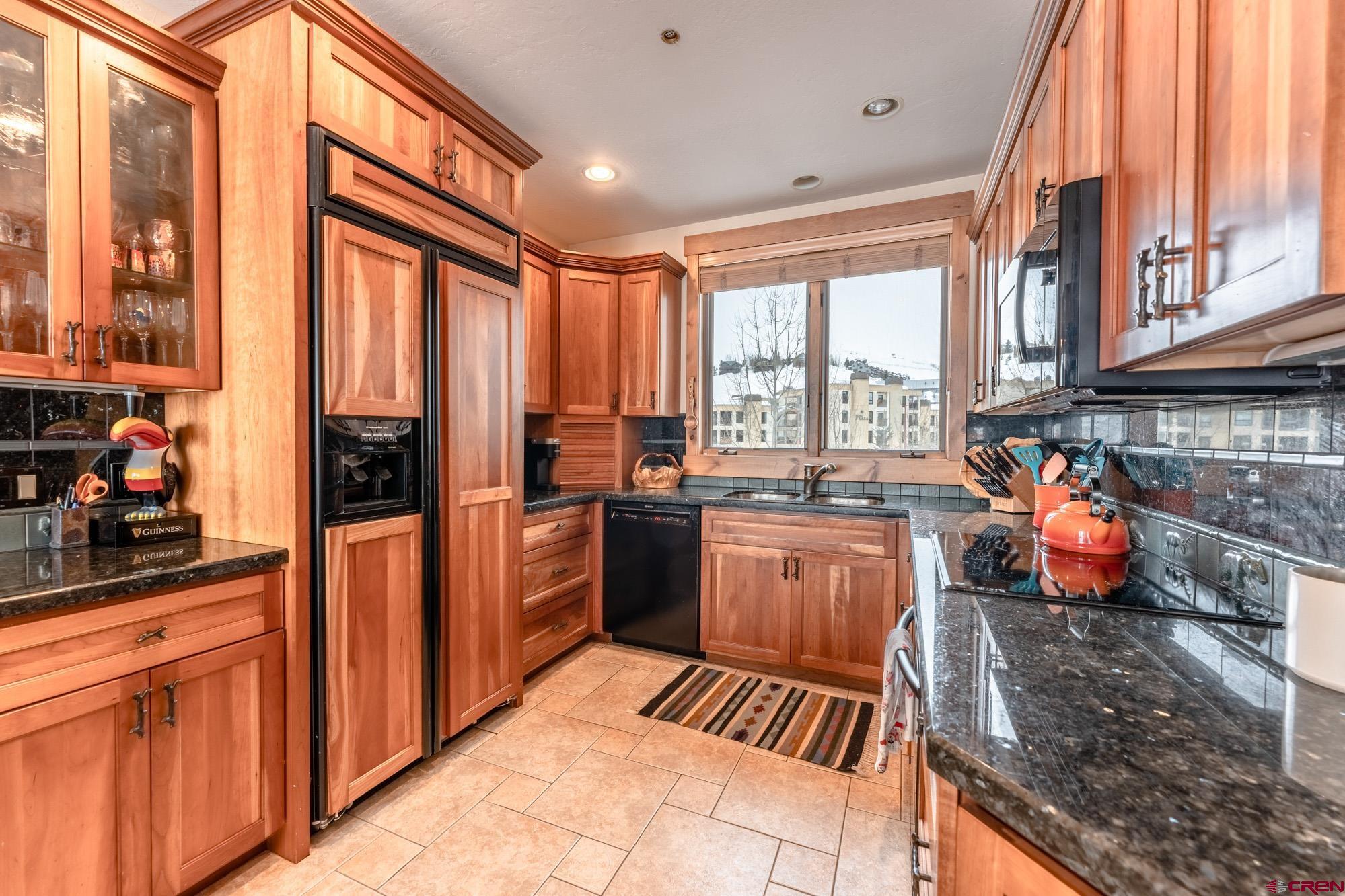 16 Snowmass Road, Unit 4 Crested Butte, CO 81225 - Photo 7 of 35 a kitchen with stainless steel appliances a refrigerator and sink