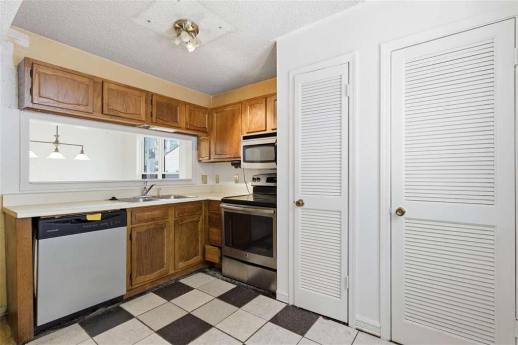 1980 Variations Drive Northeast Atlanta, GA 30329 - Photo 12 of 26 a kitchen with stainless steel appliances granite countertop a refrigerator and a sink