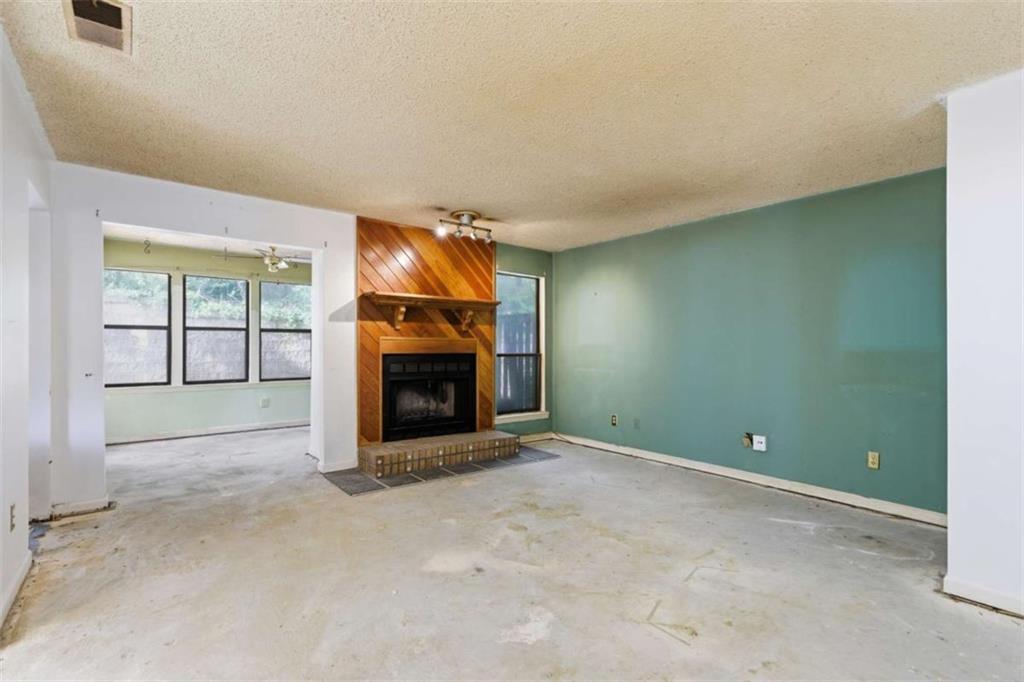 1980 Variations Drive Northeast Atlanta, GA 30329 - Photo 4 of 26 an empty room with a fireplace and window