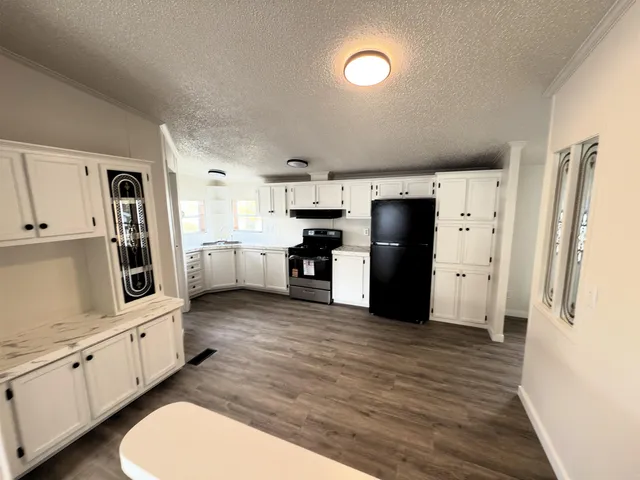 a kitchen with stainless steel appliances a refrigerator stove microwave and cabinets