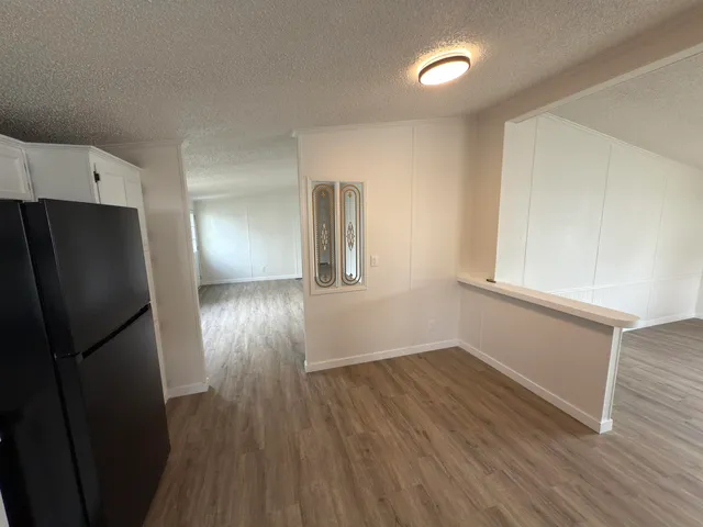 a view of hallway with wooden floor