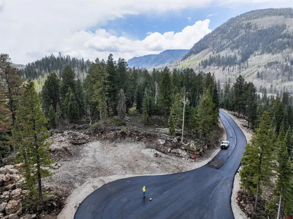 a view of a wooden floor with a bench in a yard