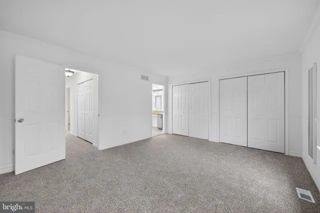 a view of an empty room and closet area