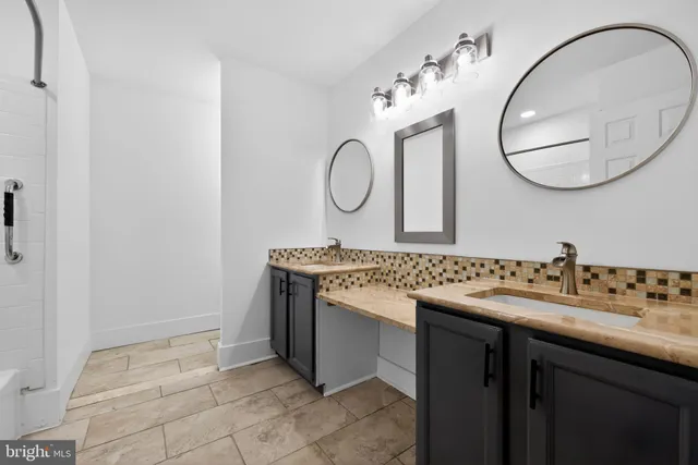 a bathroom with a sink mirror and vanity