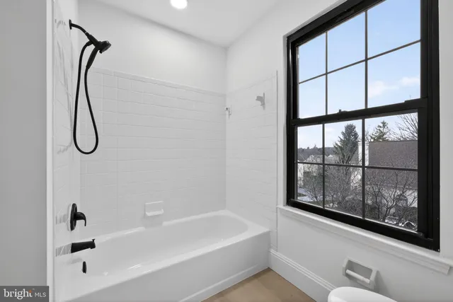 a bathroom with a bathtub and a shower