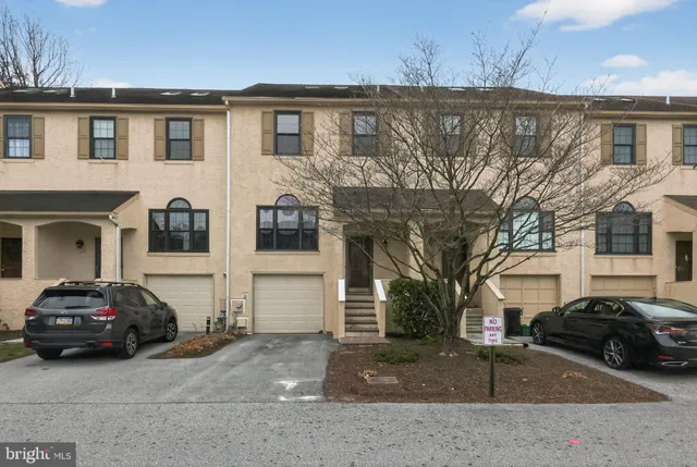a view of a car parked in front of a house
