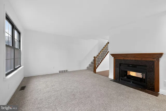 a view of an empty room with a fireplace