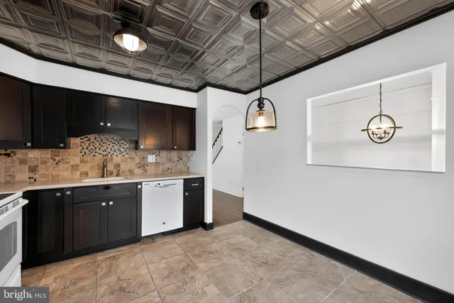 a kitchen with a sink stainless steel appliances and cabinets