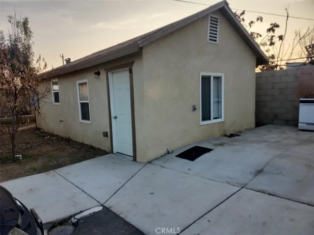 a backyard of a house with shaded area