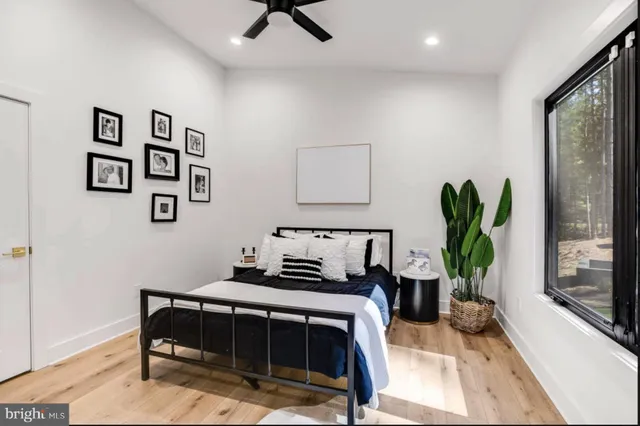 a living room with furniture a table and a large window