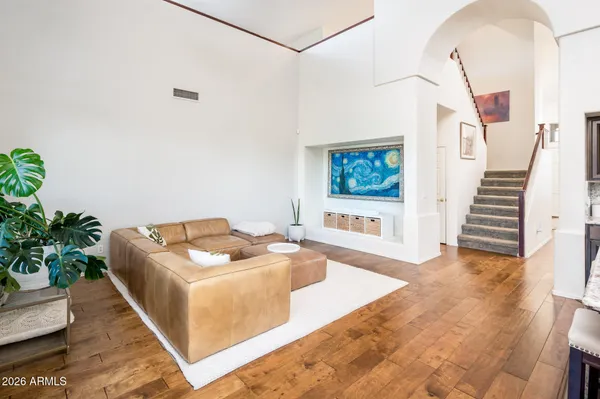 a living room with furniture and a potted plant
