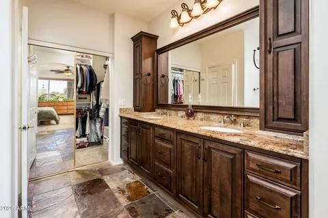 a bathroom with a double vanity sink and a mirror