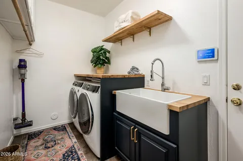 a utility room with sink dryer and washer
