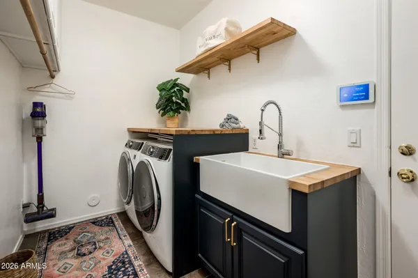 a utility room with sink dryer and washer