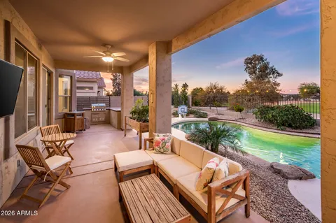 a view of a patio with couches chairs potted plants and a big yard