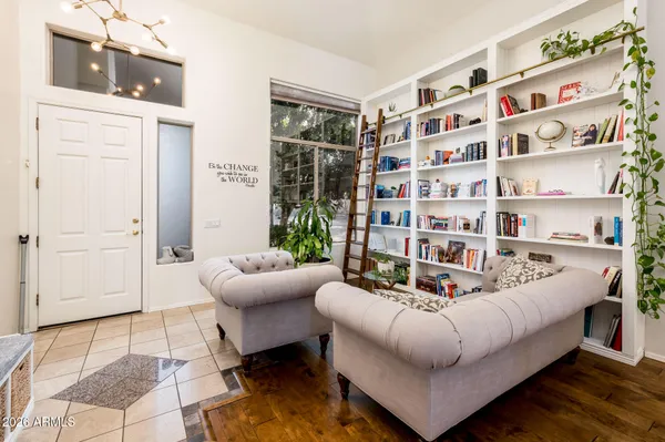 a living room with furniture and a book shelf