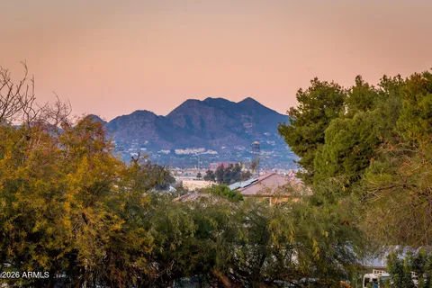 a view of a house with a mountain in the background