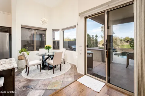 a view of a living room and a floor to ceiling window and an entryway