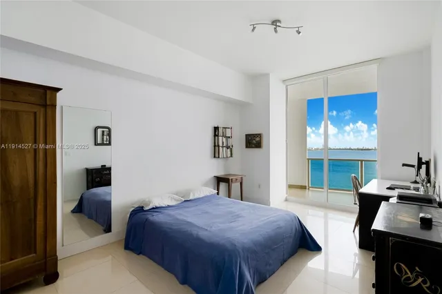 a bedroom with a bed and a desk