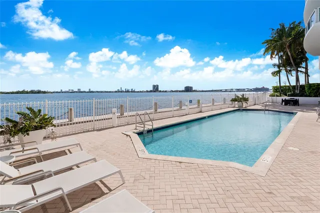 a view of a swimming pool with a lounge chair