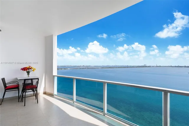 a view of a chairs and table in the balcony