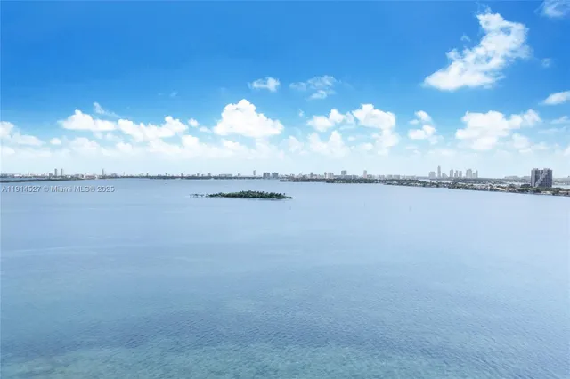 a view of a lake with houses in the back