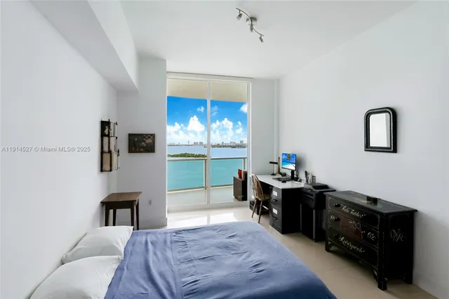 a bed room with a bed and a television