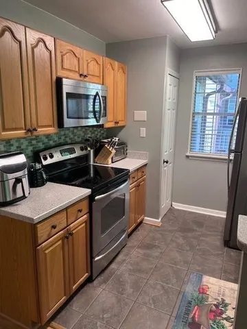 a kitchen that has a sink and a stove in it