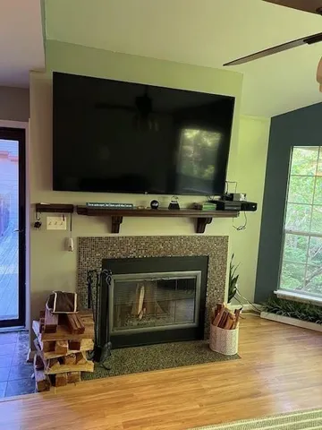 a living room with a fireplace a flat screen tv and a fireplace