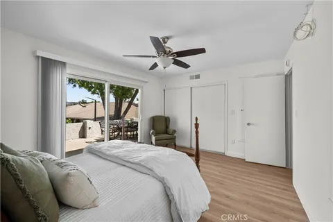 a bedroom with a large bed and a large window