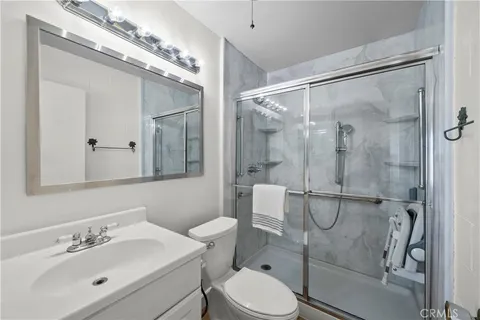 a bathroom with a sink mirror vanity and toilet
