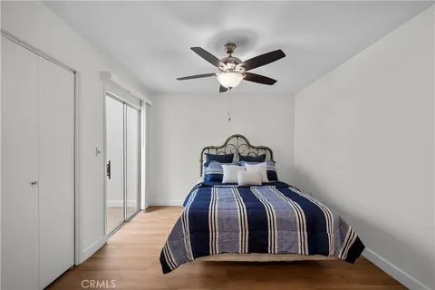 a bedroom with a bed and a ceiling fan