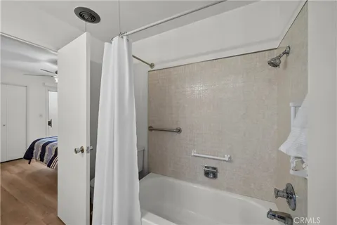 a bathroom with a bathtub and a shower