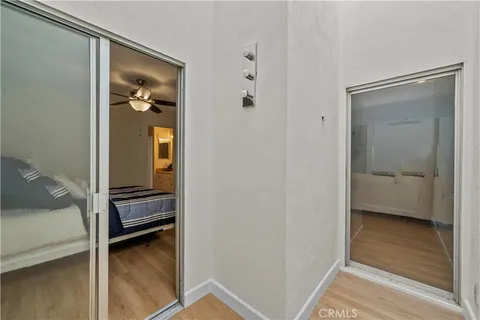 a view of a bedroom with a bed and a hallway