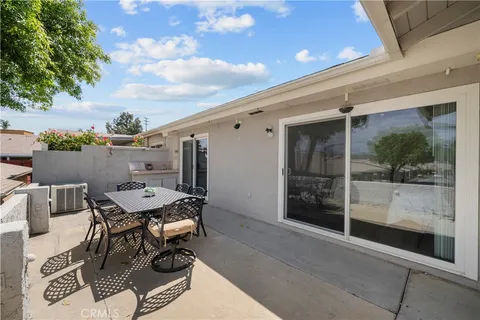 a view of a patio with table and chairs and potted plants