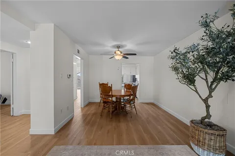 a dining room with furniture wooden floor a chandelier