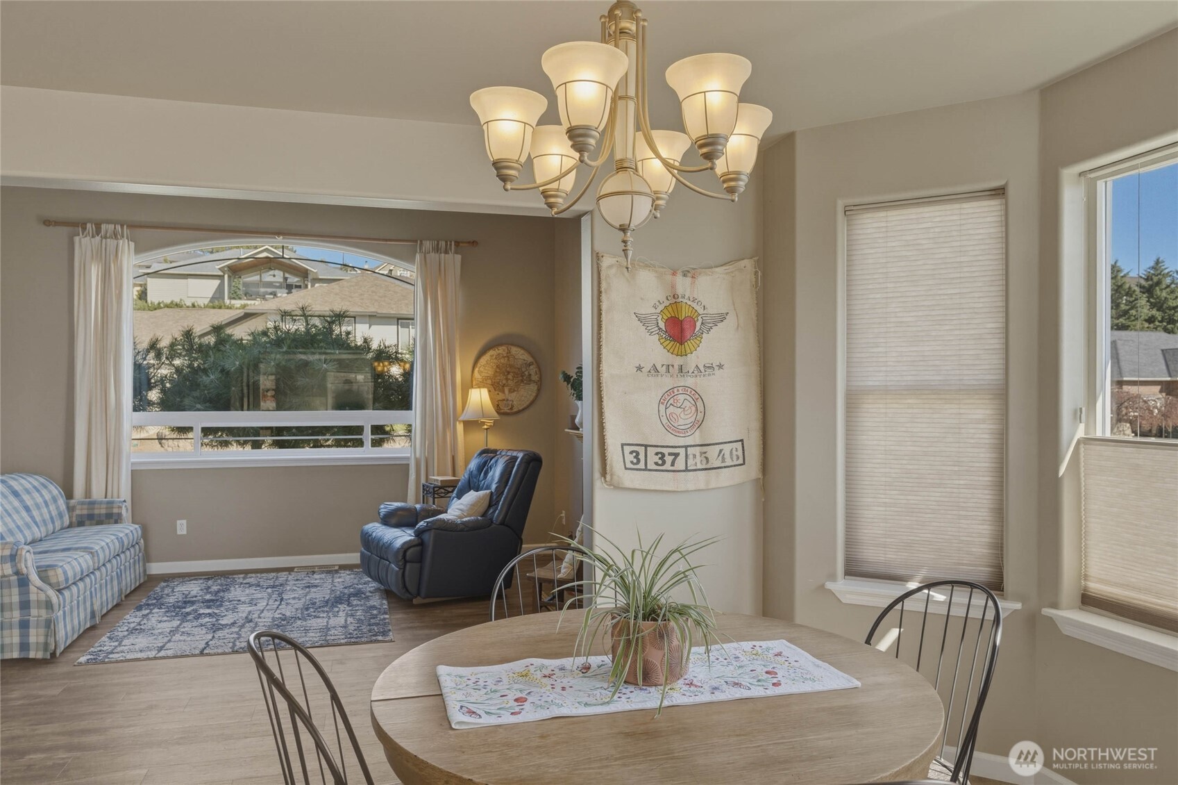2217 Michael Brooke Wenatchee, WA 98801 - Photo 13 of 37 a dining room with wooden floor a chandelier a glass table and chairs