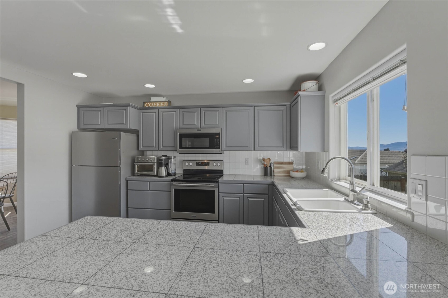 2217 Michael Brooke Wenatchee, WA 98801 - Photo 17 of 37 a large kitchen with a large counter top stainless steel appliances and cabinets