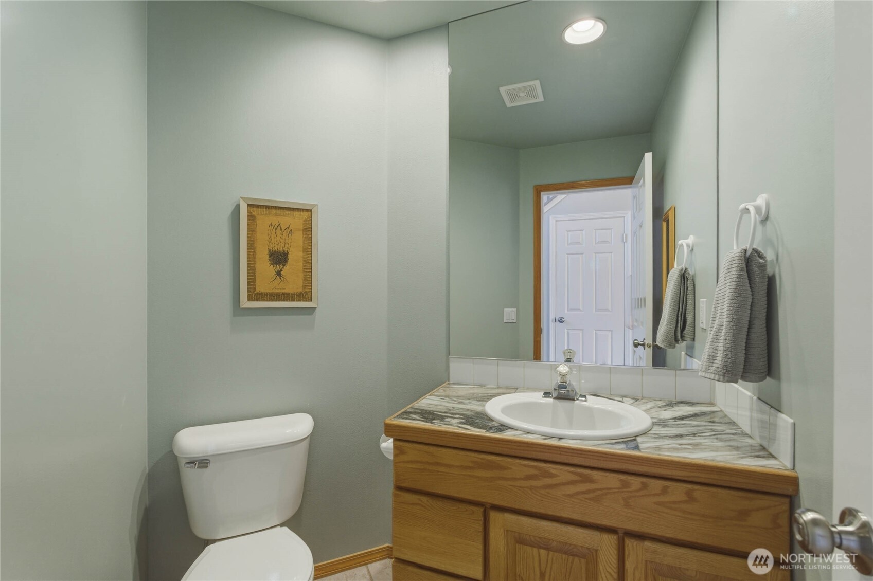 2217 Michael Brooke Wenatchee, WA 98801 - Photo 19 of 37 a bathroom with a granite countertop toilet sink and mirror