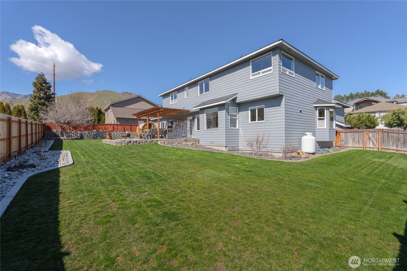 2217 Michael Brooke Wenatchee, WA 98801 - Photo 33 of 37 a front view of a house with a garden and yard