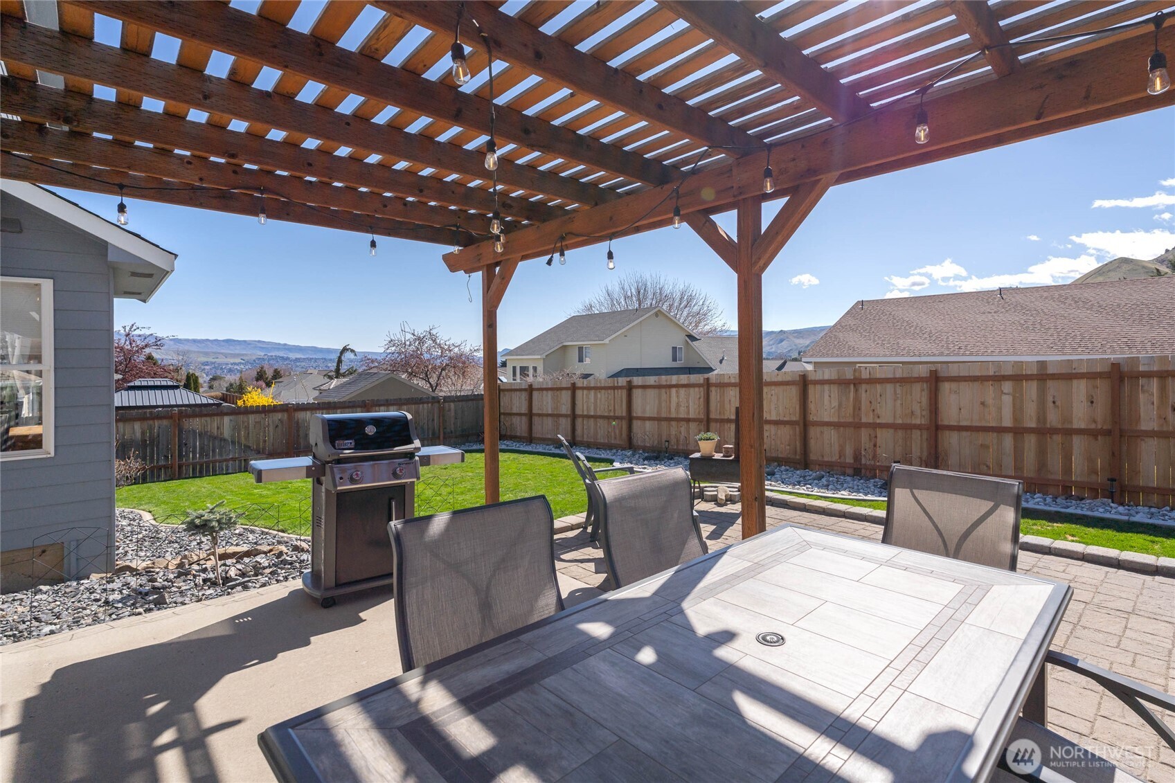 2217 Michael Brooke Wenatchee, WA 98801 - Photo 34 of 37 a view of a patio with couches dining table and chairs with wooden floor