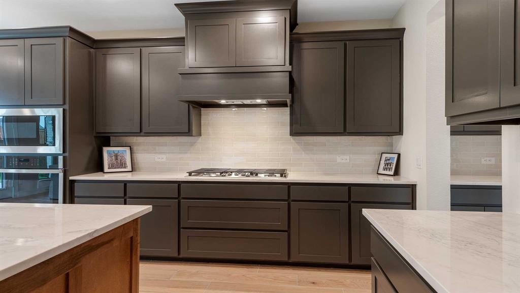 854 Stoney Bridge Way Lavon, TX 75166 - Photo 7 of 36 a kitchen with a sink a stove and cabinets