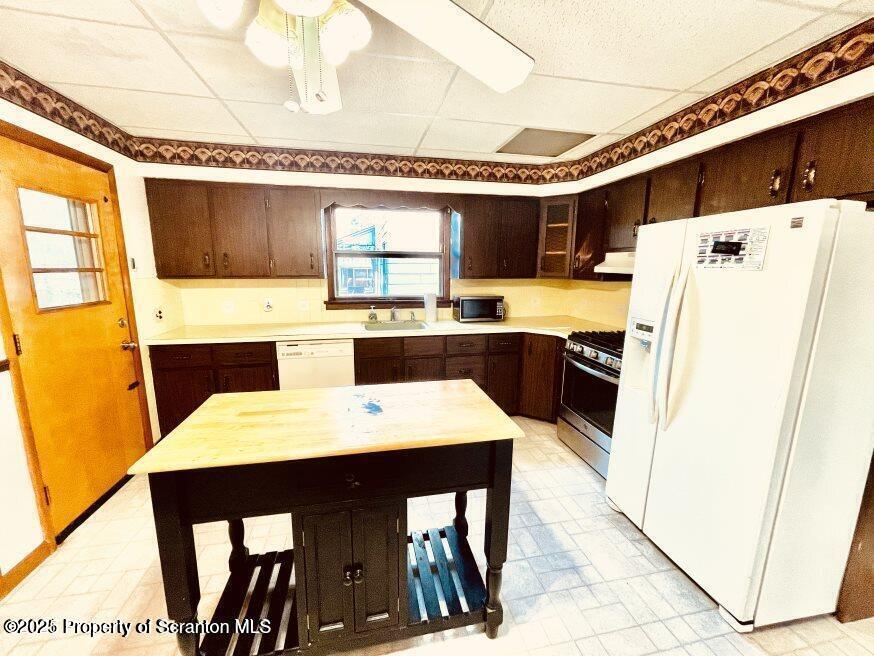 1630 Myrtle Street, Unit 1 Scranton, PA 18510 - Photo 17 of 25 a kitchen with stainless steel appliances kitchen island a table chairs and sink