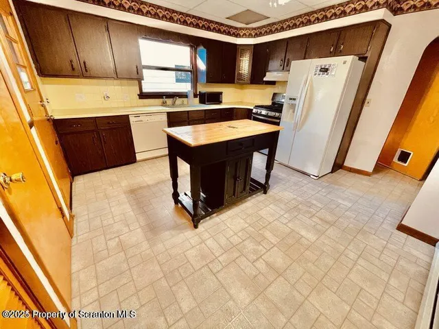 a kitchen with refrigerator and window