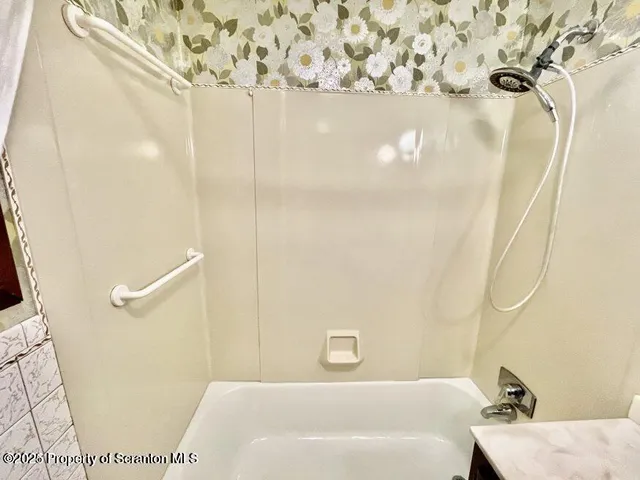 a bathroom with a bathtub and shower
