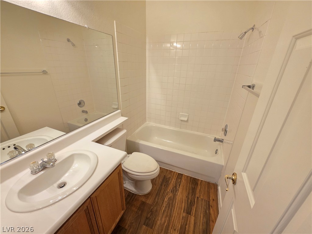 1154 Point Success Avenue Henderson, NV 89014 - Photo 12 of 26 A well-appointed bathroom offers a convenient vanity, toilet, and a clean tub-shower combination.