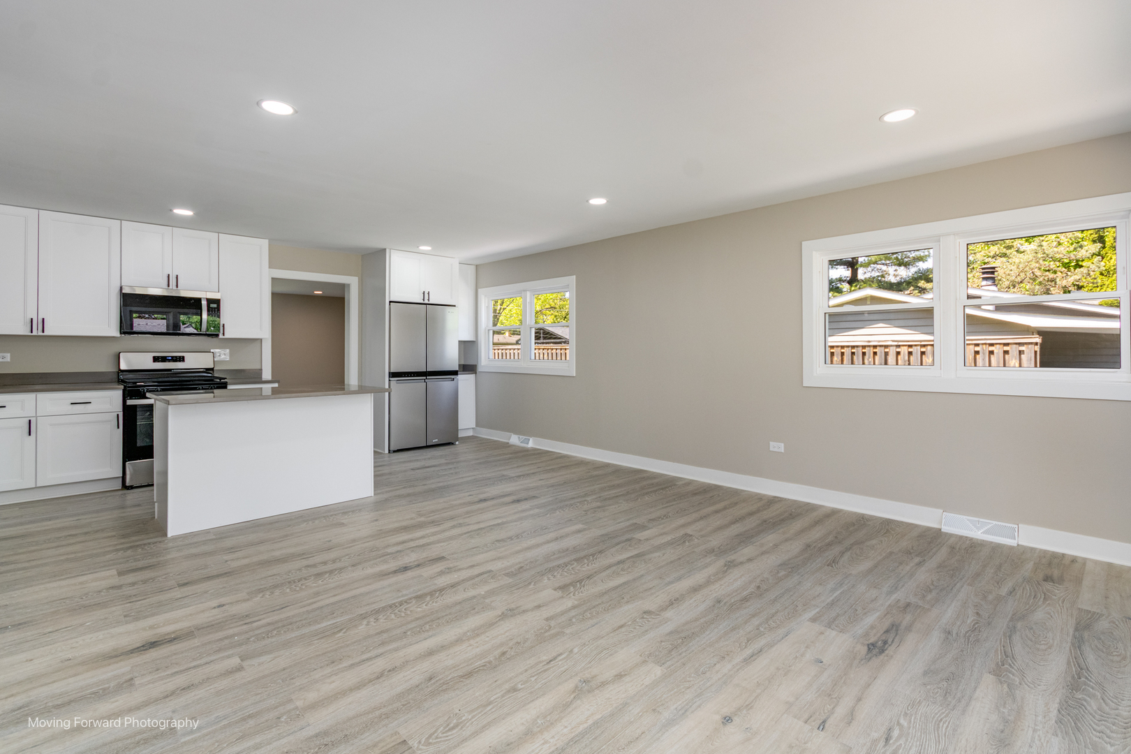11 Durango Road Montgomery, IL 60538 - Photo 12 of 36 a view of a kitchen with microwave and wooden floor